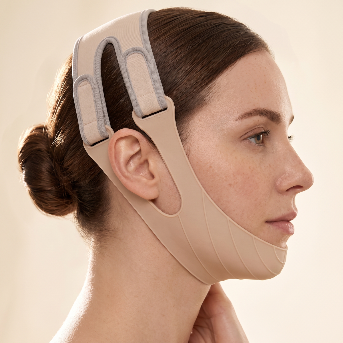 Woman adjusting the Revitune V-Line Face Sculpt Band straps